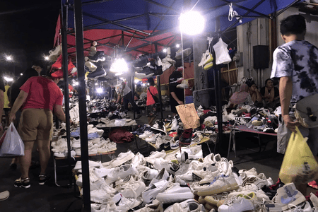 Shopping second-hand shoes at Colon Night Market at an affordable price