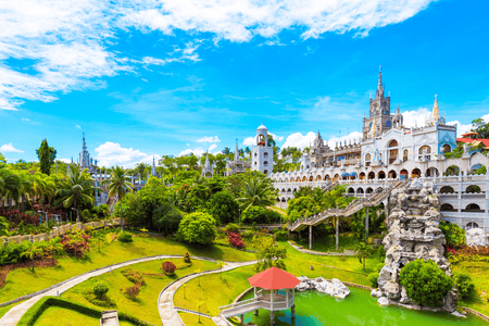 Facade of Simala Shrine with lush landscape