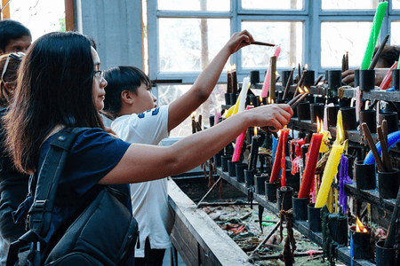 Pilgrims lighting colorful candles at Simala Shrine