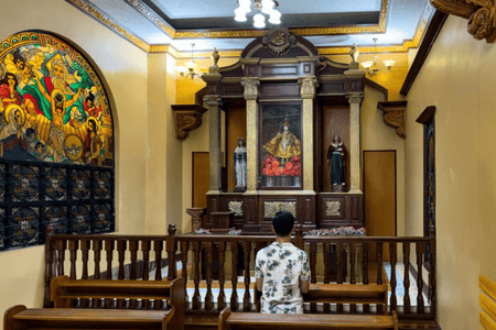 Person praying at a chapel inside Simala Shrine