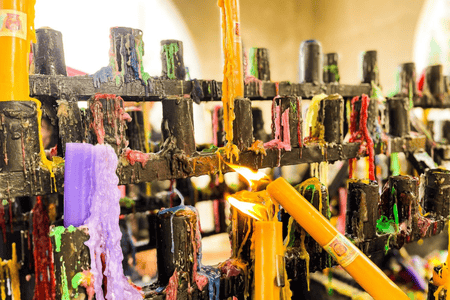 Lit and melted colorful candles at Simala Shrine