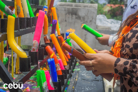 People in prayer and offering candles at Simala Shrine
