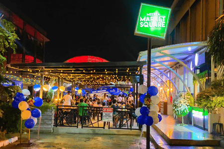 Bright and colorful Flambe Alley Food Park with people dining