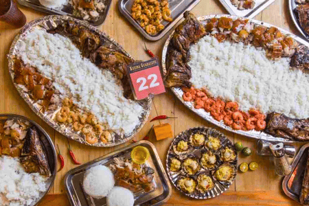 Platters of Filipino cuisines such as lechon, grilled pork, shrimps, scallops served with rice