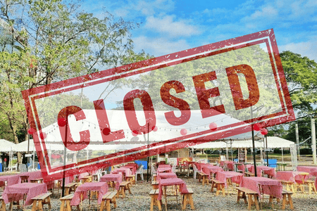 A photo of a food park with a "Closed" sign stamped on it