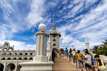 People visiting the Simala Shrine on a sunny day