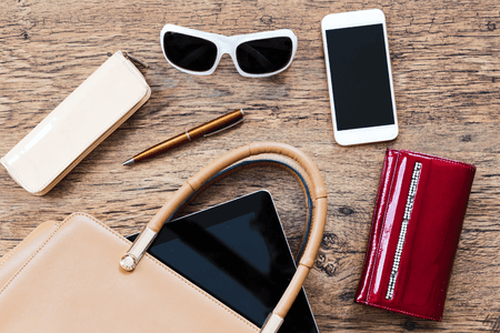 Valuables like phoine, tablet and wallet with a bag