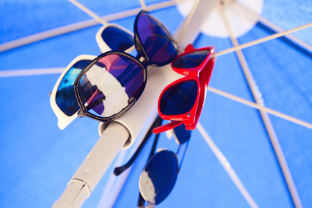 Sunglasses hanged at an umbrella