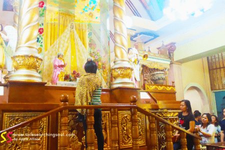 Woman with a shawl praying to the Virgin Mary at Simala Shrine