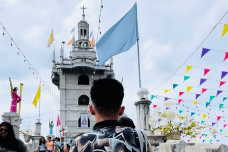 People visiting Simala Shrine adorned with streamers