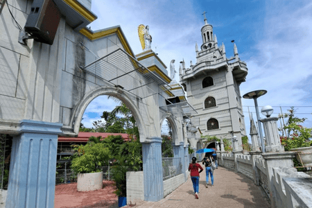 People visiting the Simala Shrine on a sunny day