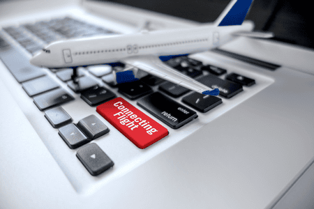 toy plane on a laptop keyboard