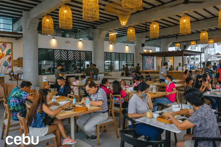 people enjoying food at a restaurant in Cebu